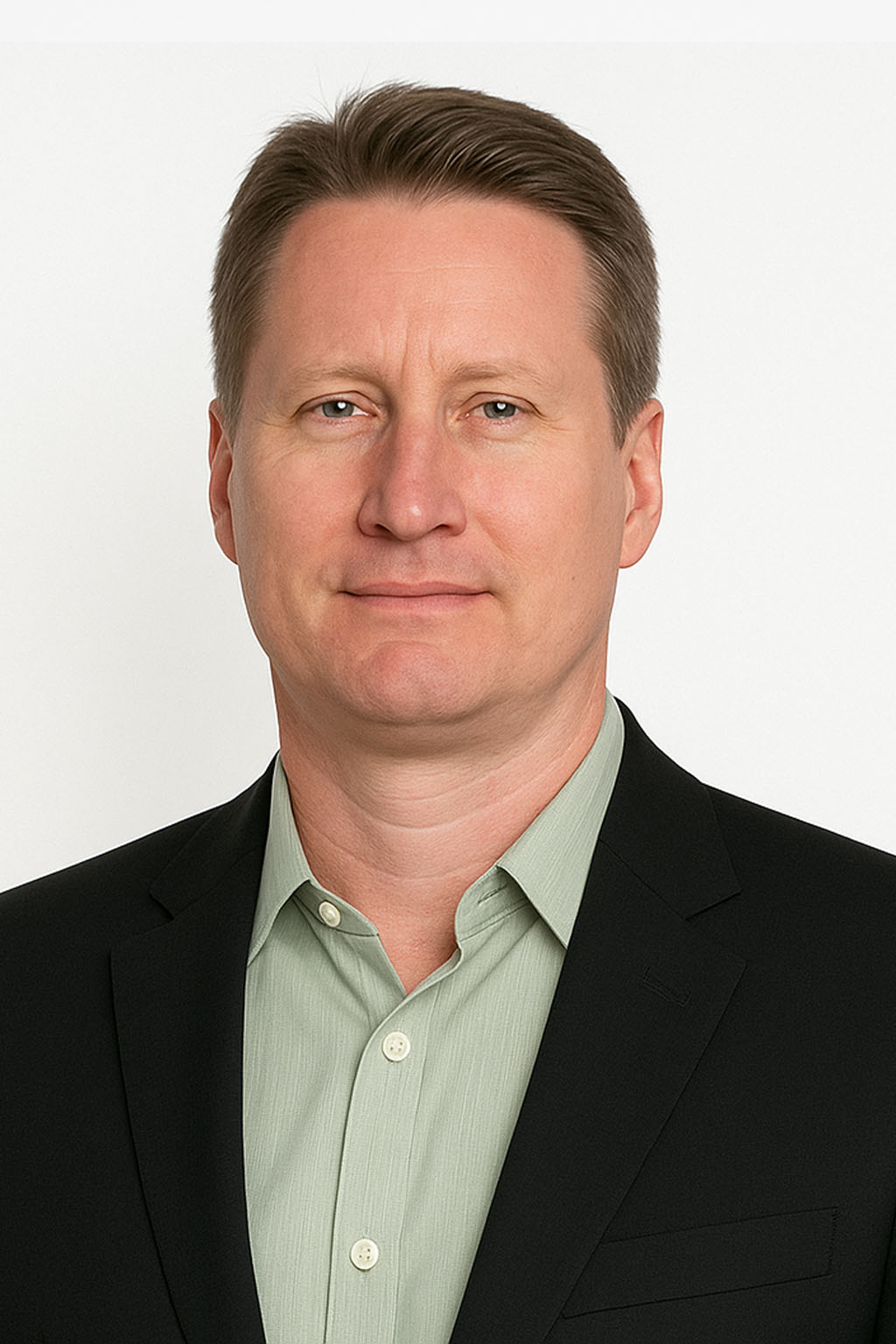 Professional headshot of a man wearing a black blazer and light green shirt, facing forward against a white background.