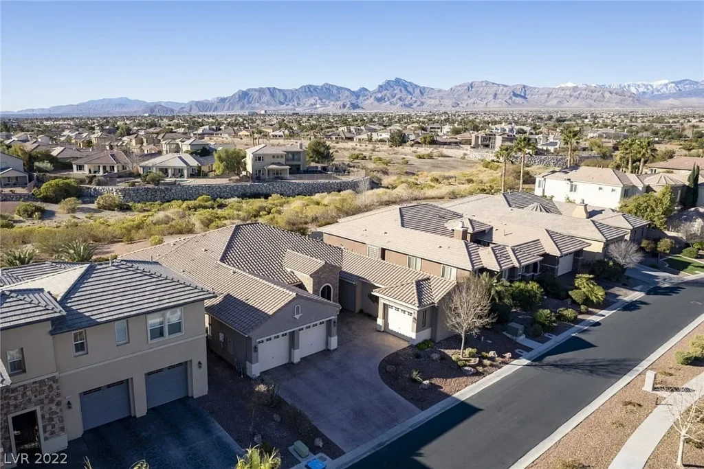 Aerial view of a Las Vegas suburban neighborhood with desert landscaping and mountain views.
